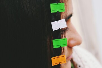 Closeup image of young womans hair attached to empty price tag labels 