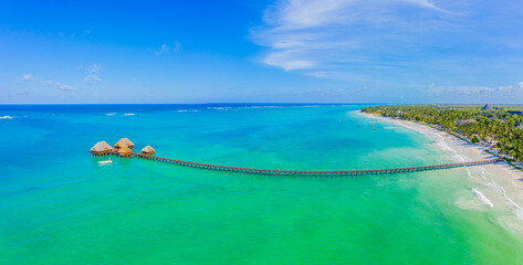 Aerial view of palms on the sandy beach of Indian Ocean at sunny day. Summer holiday in Zanzibar,...