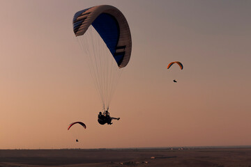 Paragliding from a mountains on an autumn evening 