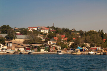 Fototapeta na wymiar A view of a Sevastopol bay coact from a deck of ship. Houses on slope by the sea