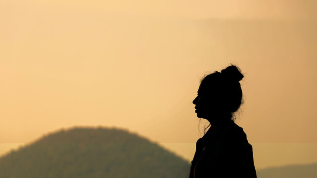 Silhouette Of Solo Young Traveller Girl Enjoying The Sunset