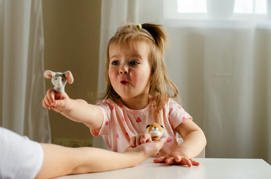 Little Expressive Girl And His Brother Playing Theater With Animal Finger Puppets. Role-playing Games And Activities  To Improve Language Skills, Creativity, Social Awareness, Emotional Development