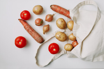 Delivery healthy food background. Vegan vegetarian food in bag. vegetables on white, copy space. Grocery shopping food supermarket and clean eating concept. Zero waste.