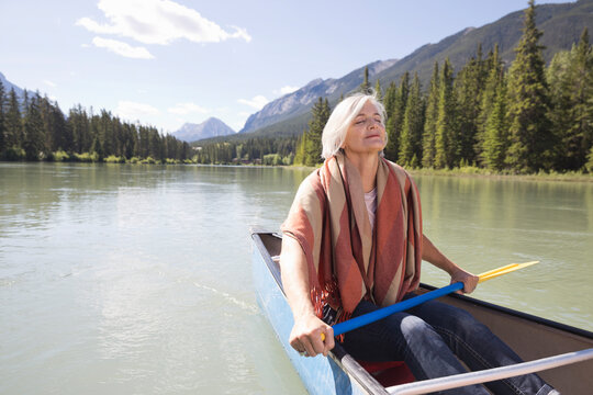 Mature Woman Relaxing On Canoe Ride