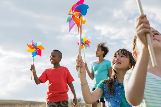 Smiling children holding pinwheels during field trip