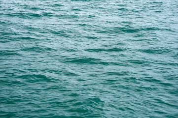 A close-up of the ocean wave surface wallpaper in the sunlight