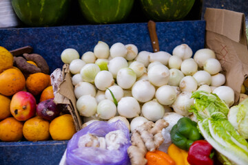 Colorful fruit stand with watermelons, oranges, mangoes, and more
