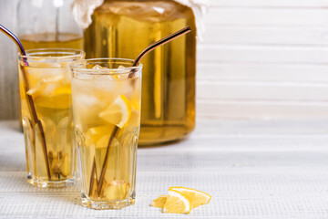 Homemade fermented kombucha tea drink with lemon and ginger