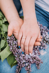 Fototapeta premium man holds the hand of his beloved with a wedding ring on his finger