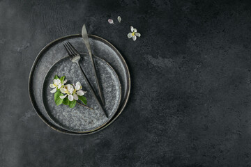 Plase table setting with blossoming apple tree branches and flowers