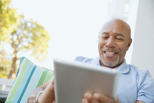 Happy Senior Man Using Digital Tablet