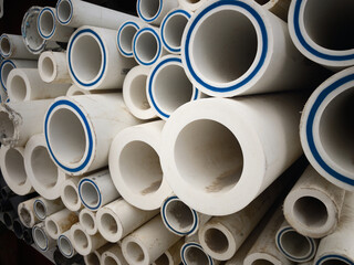 Polypropylene pipes stacked at construction site. Stack of LDPE water pipes. PVC pipes