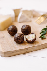 Healthy handmade chocolate candies on wooden background. Natural