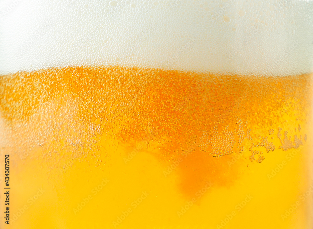 Wall mural beer and foam close-up background. beer texture