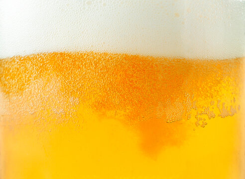 Beer and foam close-up background. Beer texture