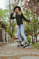 Young woman roller skating on spring day