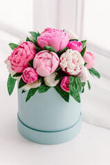 Pink flowers made from soap in hatbox. Natural