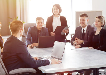 Group of young successful businessmen lawyers communicating together in a conference room while working on a project