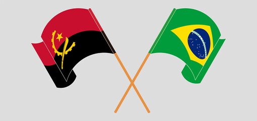 Crossed and waving flags of Angola and Brazil