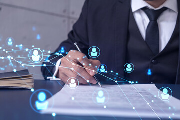A potential employee in formal suit signing the contract to boost his career and gain new opportunities in personal growth. Concept of success. Hiring a new talented crew. Social media hologram icons