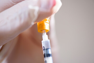 A girl fills a syringe for insulin injections. Diabetes. The short-acting insulin. Insulin injection at home.