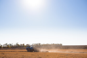 Farmer preparing his field in a tractor ready for spring.