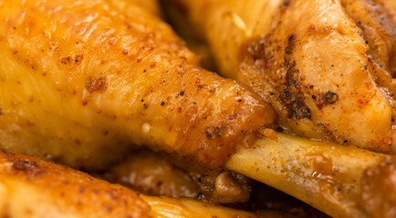 Fried roasted chiken close-up background, chicken legs after grill with golden color