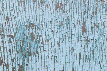 Macro photography of cracked surface of blue wooden painted wall.
