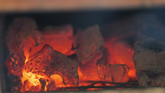 Charcoal flame burning in BBQ pit stove
