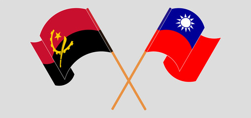 Crossed and waving flags of Angola and Taiwan