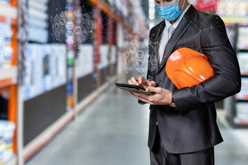 Construction engineer makes calculations against the background of a warehouse .