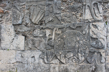 Detail of Mayan wall carving on the territory of Chichen Itza, Yucatan, Mexico. Ancient Mayan stone reliefs at Chichen Itza ruins, mexican archaeological site.