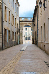 Dijon, beautiful city in France, narrow street, with the Liberation square in background
