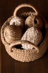 clews of jute threads in crocheted basket	