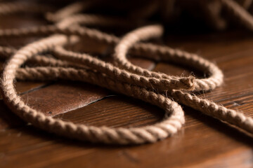 close up jute rope (cord) on wooden table and dark background