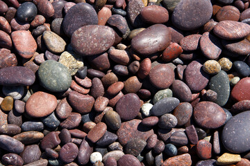Red pebble stones on a beach