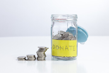 Donate jar with money stack