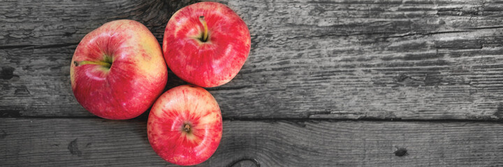 Delicious country apples closeup on the wooden handmade bench. Banner. Selective focus.