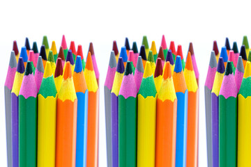 colored wooden pencils on white background