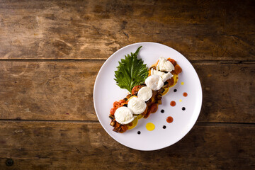 Tortelli dish with eggplant, tomato, buffalo mozzarella and a Shiso leaf. Top view