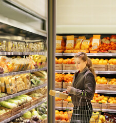 Woman buying fruits and vegetables at the market
