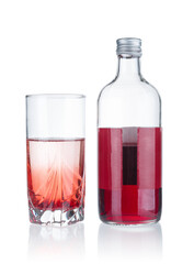 Bottle and glass with cranberry syrup isolated on white background