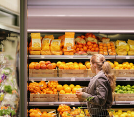 Woman buying fruits and vegetables at the market