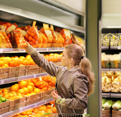 Woman buying fruits and vegetables at the market