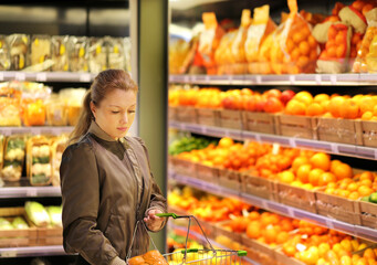 Woman buying fruits and vegetables at the market