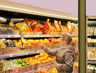 Woman buying fruits and vegetables at the market