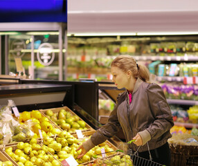 Woman buying fruits and vegetables at the market