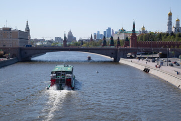 Pleasure boats ride on the Moscow River near the Kremlin.