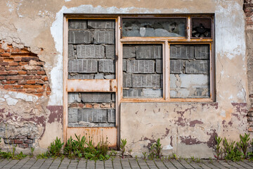 bricked-up storefront, abandoned shop, devastated store front, city decay, poverty