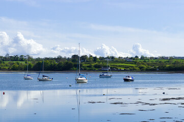 Red Wharf Bay, Anglesey. Beautiful seaside scene with small pleasure boats moored on calm placid...